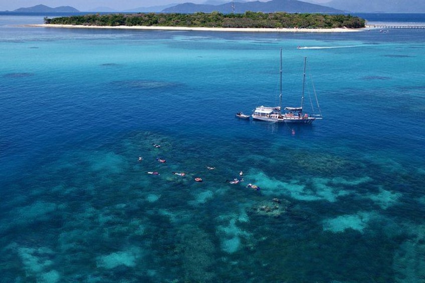 A large body of water with a sailboat and several smaller boats. 2