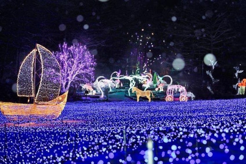 A nighttime scene with illuminated decorations including a sailboat, horses, and a carriage. 4