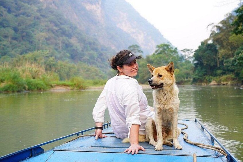 A person on a boat with a dog. 2
