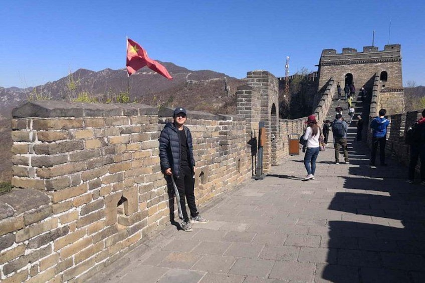 The Great Wall of China with tourists walking along it. 2