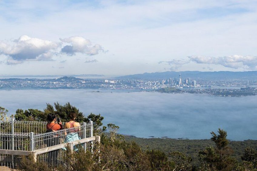 A coastal cityscape with a view of the ocean and a distant city skyline. 3