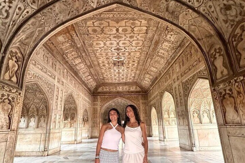 An ornate corridor with intricate carvings and arches. 2