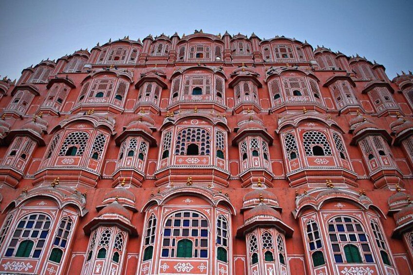 A large, ornate building with intricate architectural details and multiple windows. 1