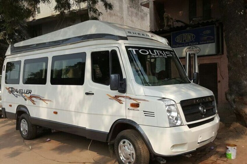 A white van with 'TOURIST' and 'TRAVELLER' written on it, parked in front of a building with a sign that reads 'Old Pont'. 3