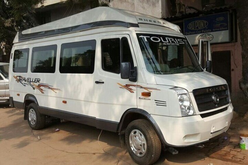 A white van with 'Tourist' and 'Traveller' written on it, parked on a street. 4