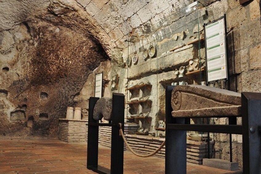An ancient cave with stone structures and artifacts. 2
