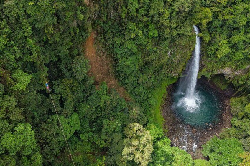 A waterfall surrounded by dense forest. 2
