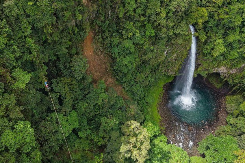 A waterfall surrounded by dense forest. 2