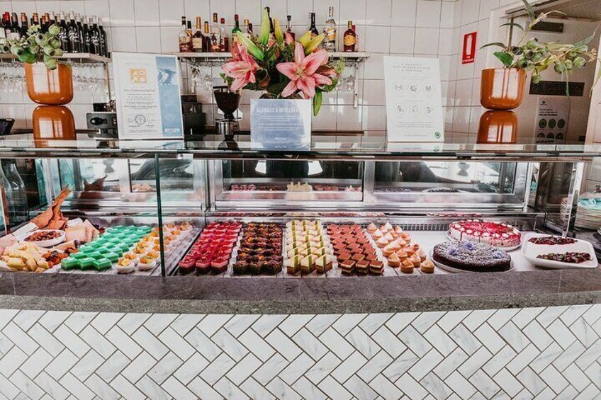 A buffet with various desserts and a selection of wines. 5