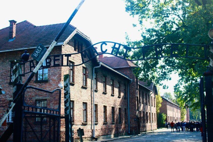 A historic building with a sign reading 'HATZBEIN' and a metal gate. 2