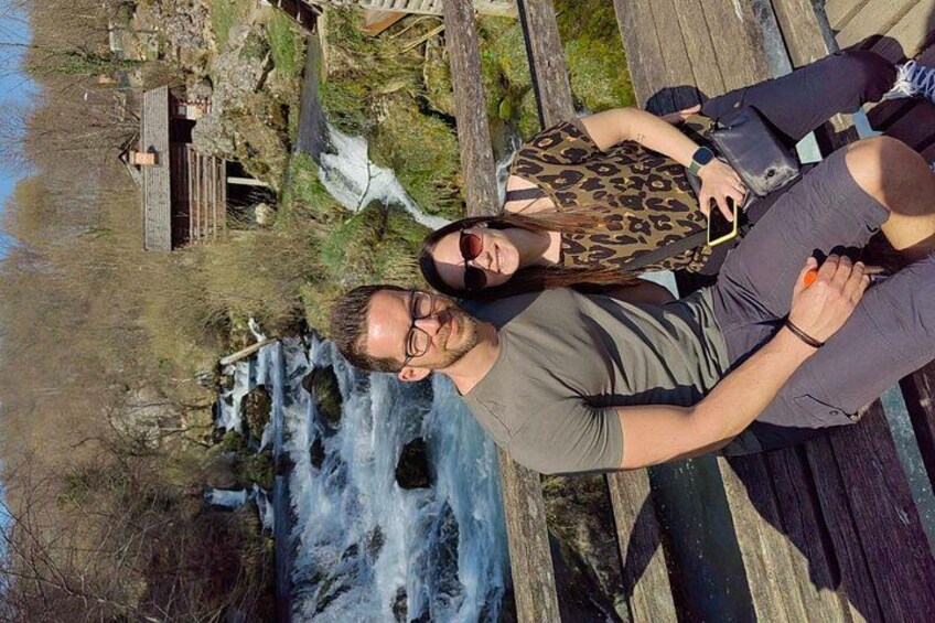 A wooden bridge with a waterfall in the background. 5