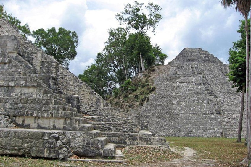 Ancient stone ruins with stepped pyramids and a clear sky. 1