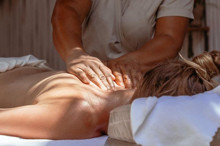 A person receiving a back massage. 3