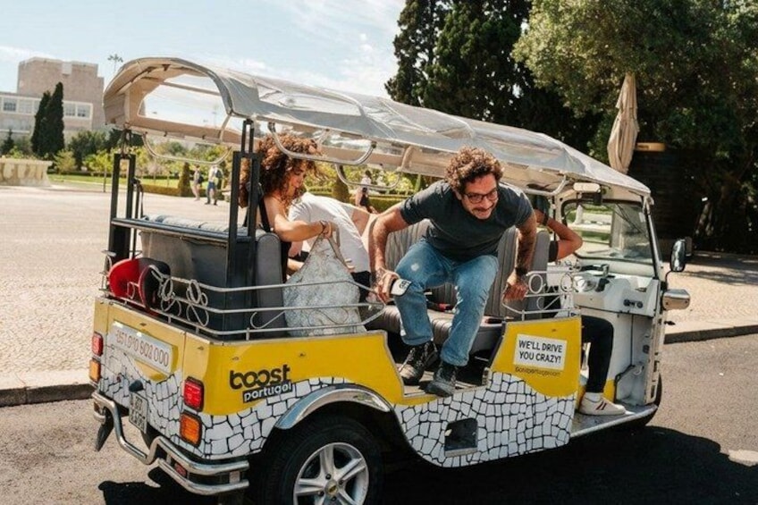 A yellow and white vehicle with a cracked pattern, labeled 'boost portugal,' parked on a street. 5