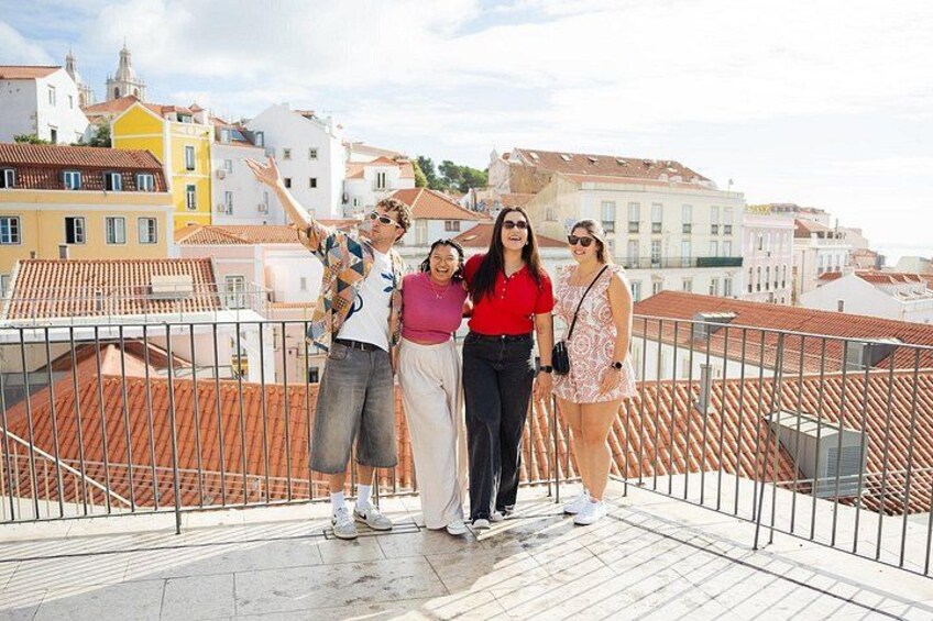 A group of friends enjoying their stop at Portas do Sol to soak in the views over Lisbon. 2