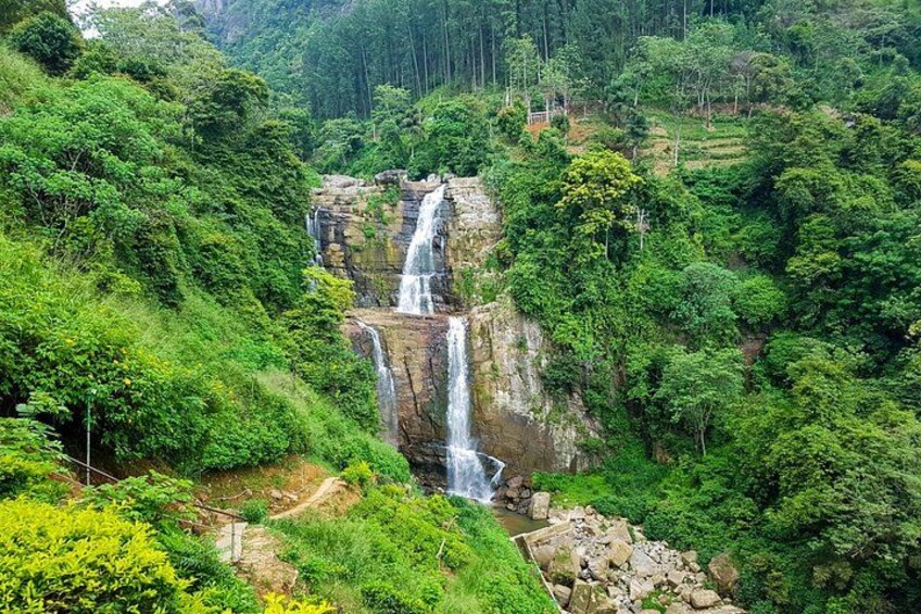 A waterfall cascading down a rocky cliff surrounded by lush greenery. 4