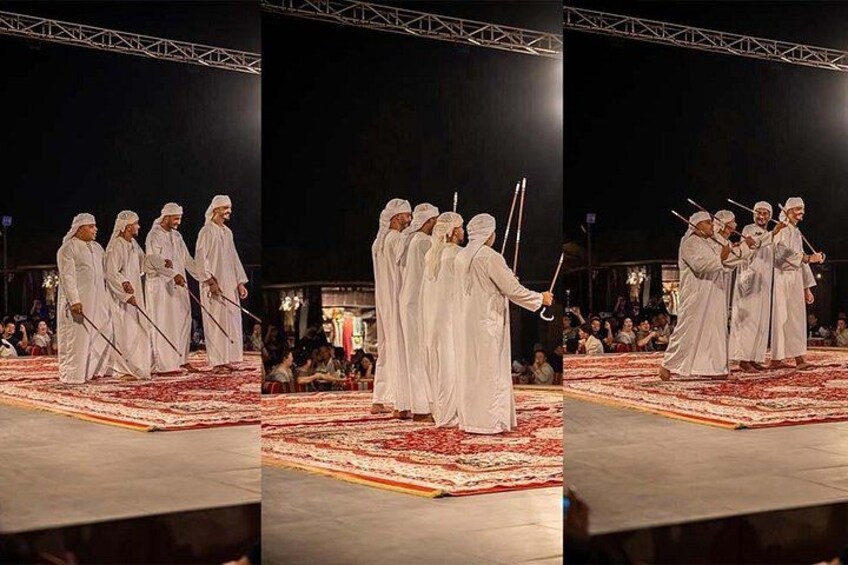 A group of people in white robes performing a ritual on a carpeted stage with an audience. 4