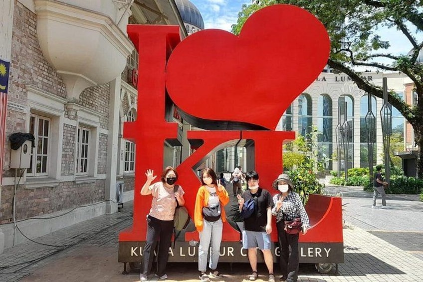 A large red heart-shaped sign with the letters 'I' and 'K' in front of a building labeled 'KUNIA LUNAR GALLERY'. 2