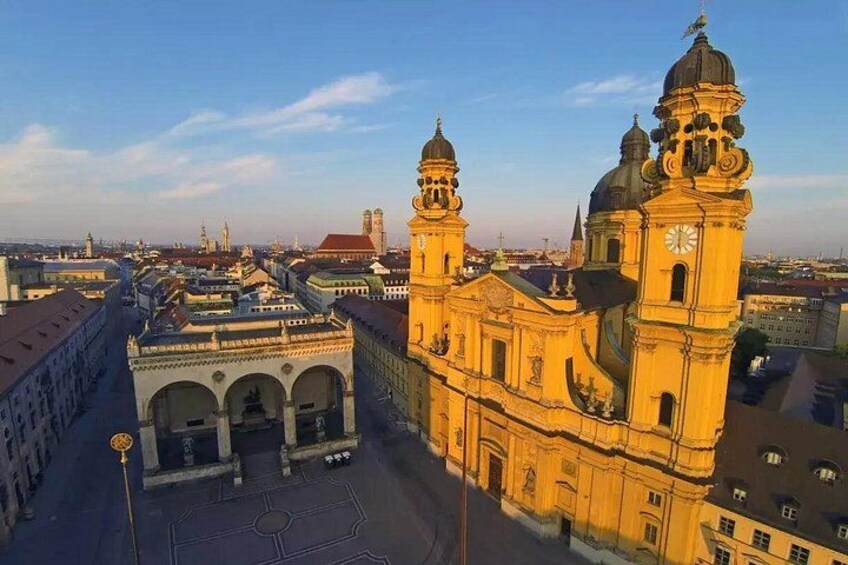 A historic building with two prominent towers and a large clock. 2