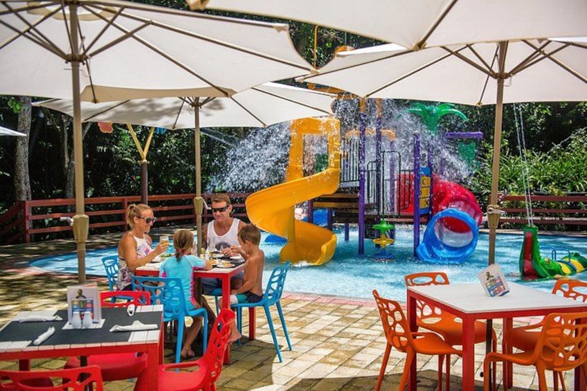 A water park with a yellow slide, a blue slide, and a water play area. 4