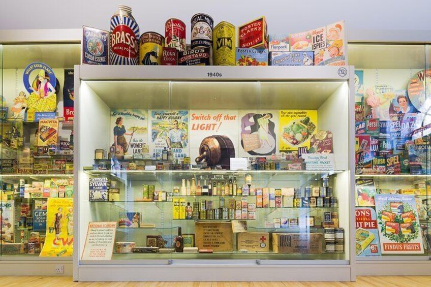 A vintage display case with canned goods and advertisements from the 1940s. 4