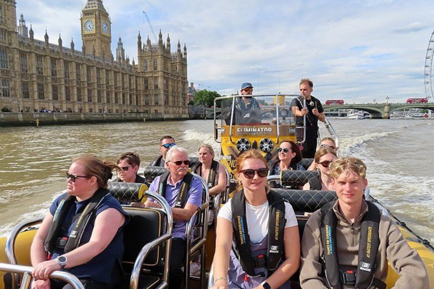 A group of people on a boat tour near a historic building. 2