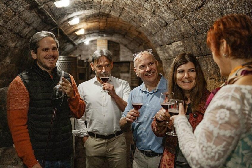 Wine tasting from the barrel in an old wine cellar 2