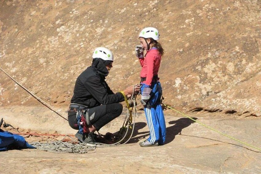 Two people climbing a rocky mountain with ropes and harnesses. 3