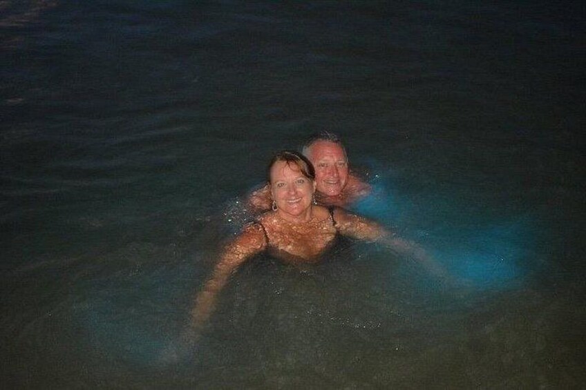 Two people swimming in clear water. 4
