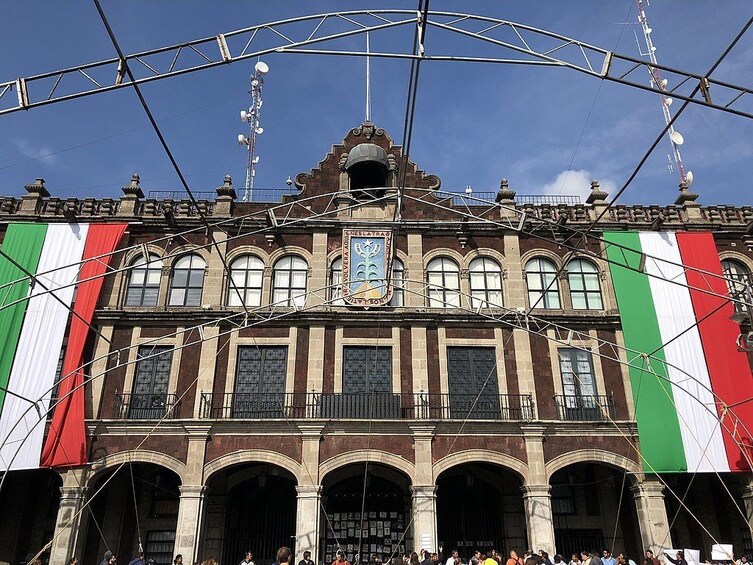 A historic building with arched windows and a central clock tower. 4