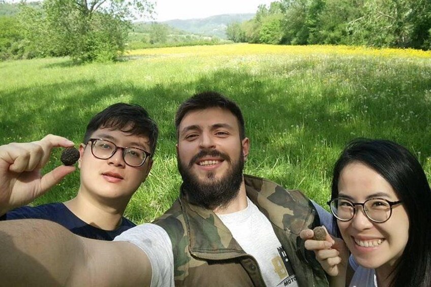 Tres personas en un campo cubierto de hierba, con árboles y cielo despejado. 3