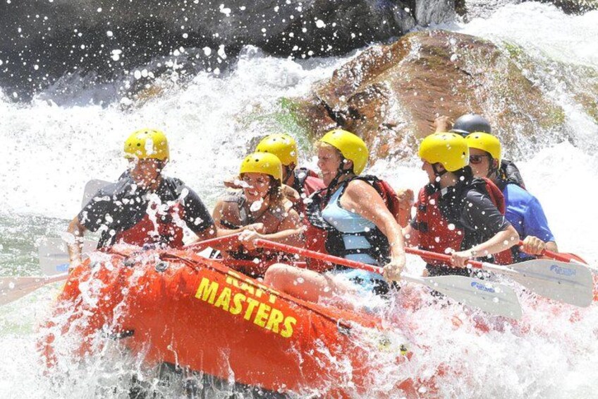 A group of people in a red raft labeled 'Masters' navigating through a water obstacle. 2