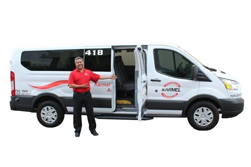 A white van with the number 418 and the name 'Karmel Air' on its side, parked with its door open. 4