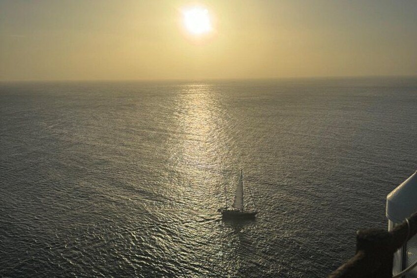 Un bateau sur une eau calme, avec le soleil bas à l’horizon. 3