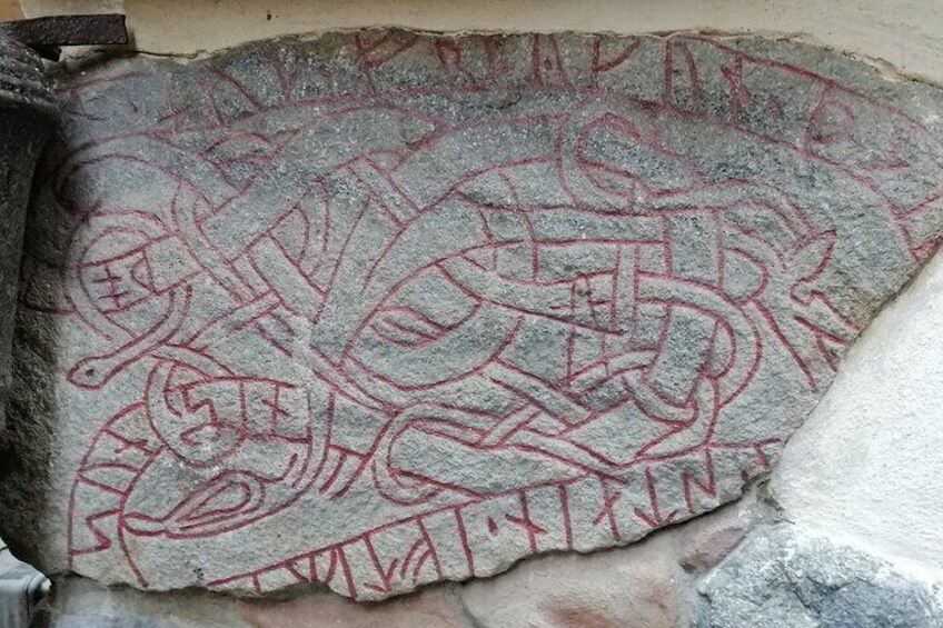 A stone with red markings, possibly ancient symbols or carvings. 3