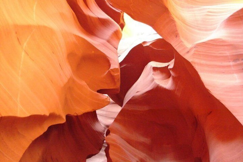 A close-up of red sandstone rock formations with smooth curves and striations. 1