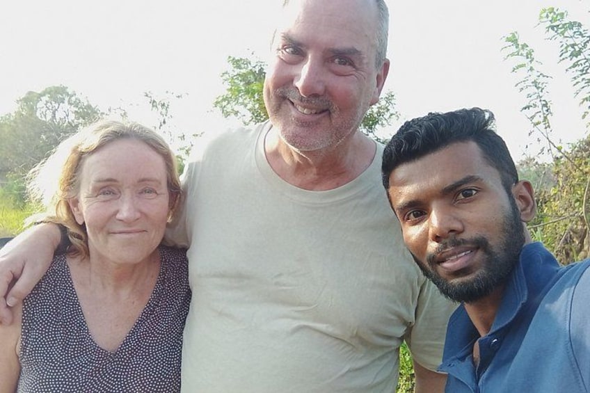 Three people standing outdoors with trees in the background. 5