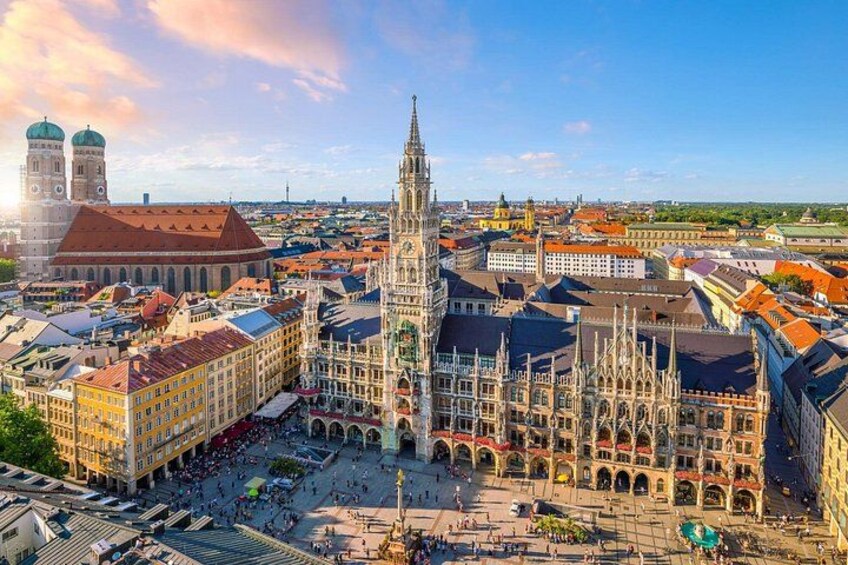 A cityscape with a prominent cathedral, a large square, and surrounding buildings. 2
