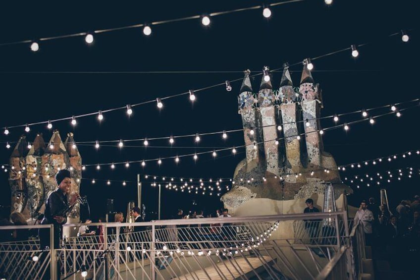 A nighttime outdoor event with string lights and a castle-like structure. 5