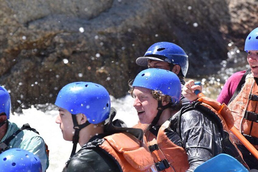 People wearing helmets and life jackets, likely engaged in a water activity. 5