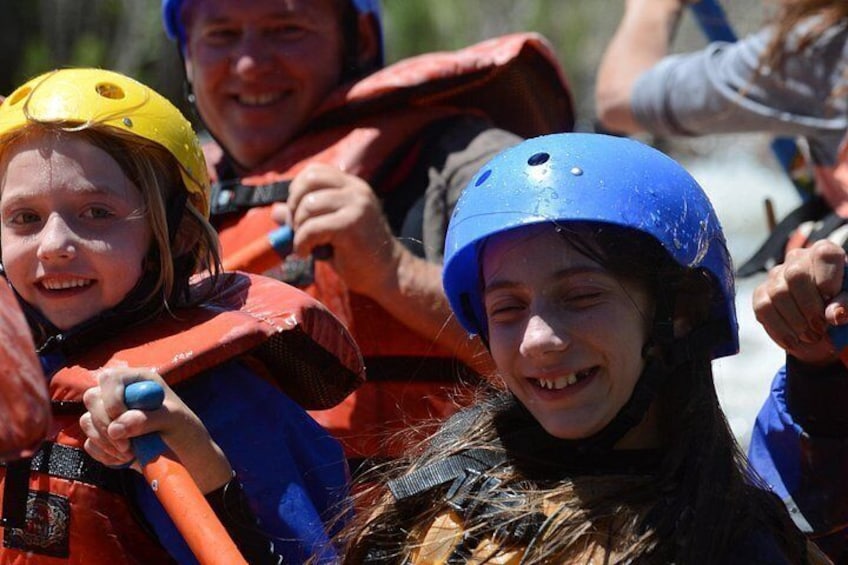 People wearing helmets and life jackets, suggesting a water activity. 3