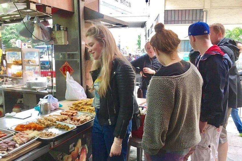 A street food vendor with various food items displayed. 1