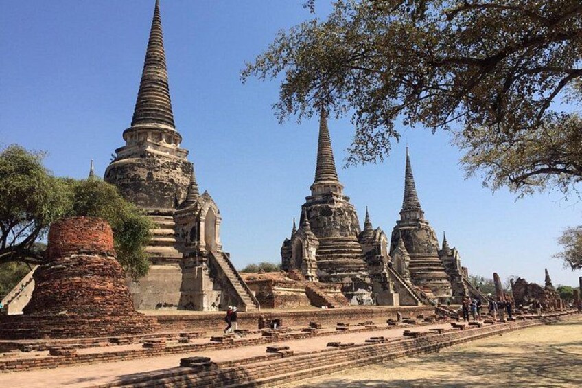 Ancient temple structures with multiple spires, surrounded by trees and open space. 5