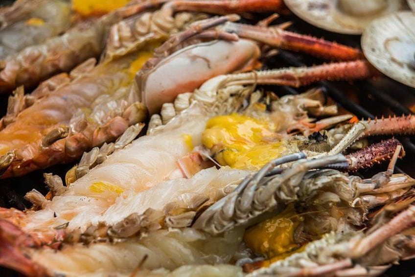 A close-up of cooked crabs with their shells partially open, revealing the meat inside. 2