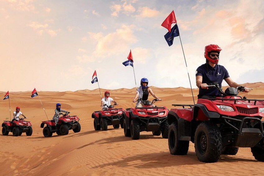 A group of people on quad bikes in a desert landscape with flags. 5