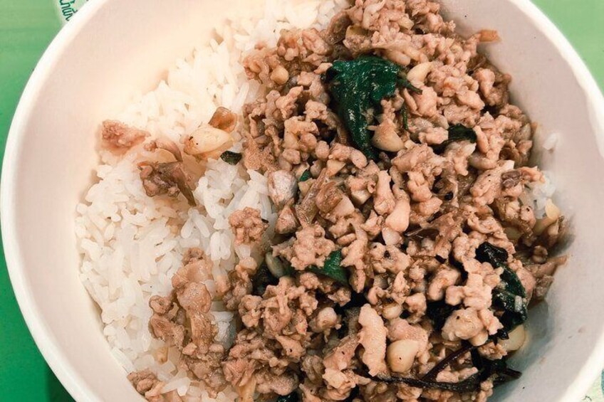 A bowl of rice and minced meat with green leafy vegetables. 5