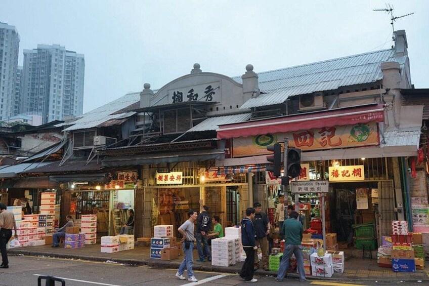 A street market with various shops and people. 3
