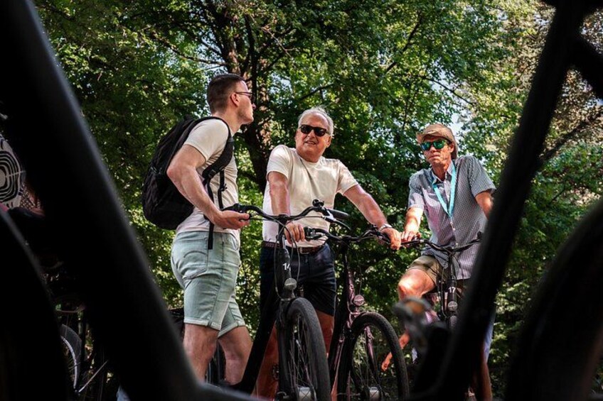 Three people on bicycles in a wooded area. 2