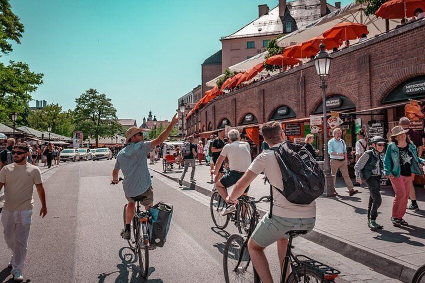 A busy street with cyclists, pedestrians, and brick buildings. 4