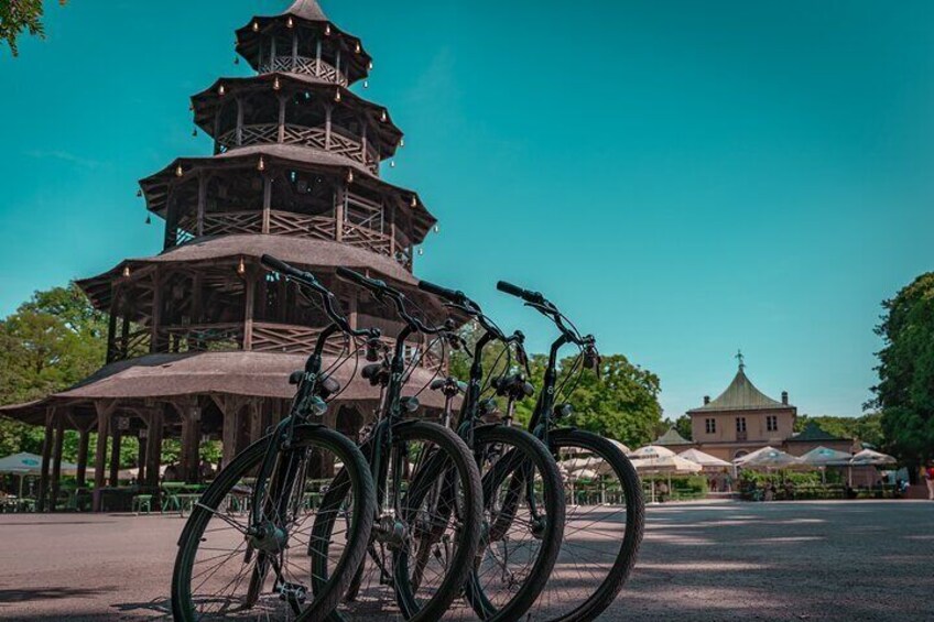 A multi-tiered wooden pagoda with bicycles parked in front. 4